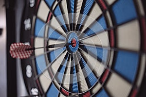 Dart hitting the center bull`s eye