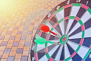 Dart hitting on center with fire on dartboard for business concept.