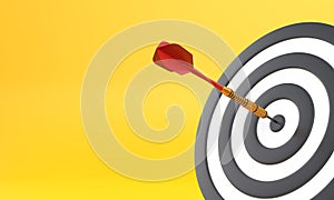 Dart hitting a target on the center on yellow background with copy space