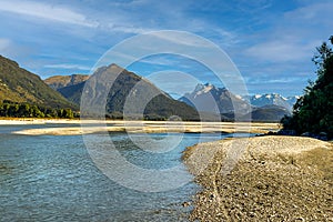 The Dart river flowing through the alpine valley towards the Southern alps mountain range on the outskirts