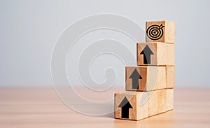 Dartboard and arrow on the top of stairs with up arrow for enhance setup business objective target and goal concept photo