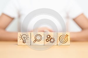 dartboard, Gear, magnifying and Lightbulb icon block on table. business planning process, goal, strategy, target, mission, action