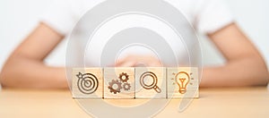 dartboard, Gear, magnifying and Lightbulb icon block on table. business planning process, goal, strategy, target, mission, action