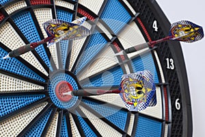 Dartboard with three darts, one hit bullseye