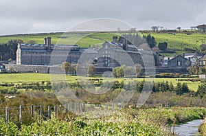Dartmoor prison, viewed from across green fields. Princetown, Dartmoor, Devon. photo