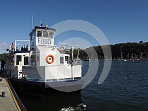 The Dartmouth ferry docked at the quayside in Dartmouth with sun and blue sky