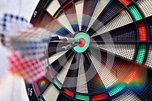 Darts arrow hitting in the target center