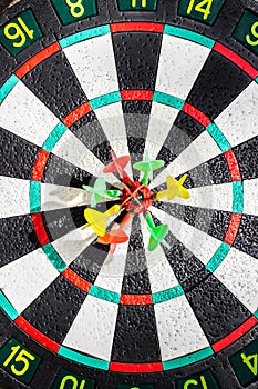 Darts arrows in the target center, closeup