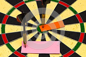 Darts with dart which was pinned a sheet of paper for labels photo