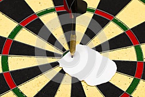 Darts with dart which was pinned a sheet of paper for labels photo