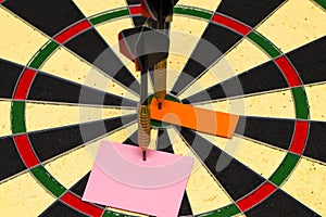 Darts with dart which was pinned a sheet of paper for labels photo