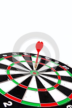 Darts. Red dart hitting the center of the target.