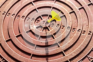 Dart target with numbers from 10 to 1. Dart in the center of the target. Goal achievement concept. Selective focus