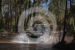 DARWIN, AUSTRALIA - Jun 06, 2020: SUV or 4x4 crossing a shallow creek