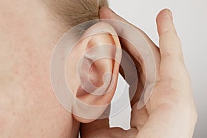 Darwin`s tubercle on the ear. The girl at the reception at the plastic surgeon, shows the auricle