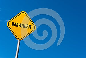 Darwinism - yellow sign with blue sky