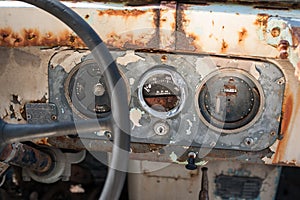 The dashboard of an abandoned, decaying car.