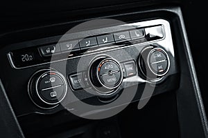 Dashboard with adjustments to air conditioning system in car close-up. Heating and ventilation of car interior.