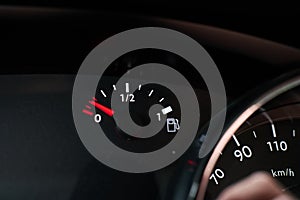 Dashboard of a car indicating that it is running out of fuel reserve