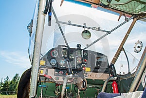 Dashboard in cockpit with analog guages of old personal plane. Closeup detailed view on engine control control panel in retro