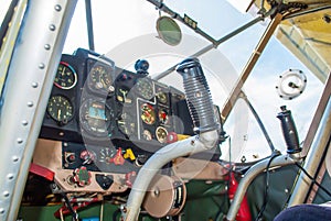 Dashboard in cockpit with analog guages of old private plane. Closeup engine control panel in vintage personal airplane