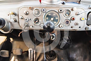 Dashboard and gear lever of an old industrial vehicle in disuse