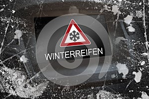 Dashboard with ice frame and the german word for winter tyres - Winterreifen