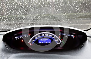 Dashboard and rain droplets on car windshield