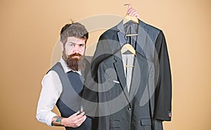 Dashing mens fashion and style. Fashion designer helping to choose suit jacket. Fashion stylist holding readymade coats