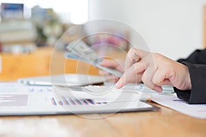 Data analysis, Financial accountants are evaluating company revenue data using calculators and databases to compute and summarize