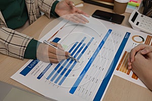 data analysis staff are helping to check data in various documents before summarizing and presenting them to the meeting, two photo