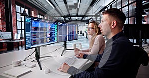 Data Analyst Analyzing Spreadsheets On Computer