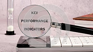 Data analytics automated with AI technology. KEY PERFORMANCE INDICATORS (KPIs) on the glass of the magnifying photo