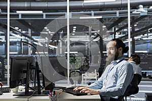 Data center admin running diagnostic scripts on PC, examining infrastructure