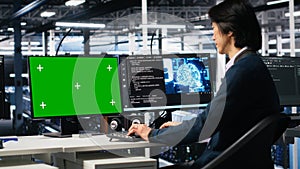 Data center admin typing on isolated screen PC keyboard, using AI