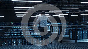 Data Center Engineer Looking Down from a Balcony on Server Farm Cloud Computing Specialist Facility