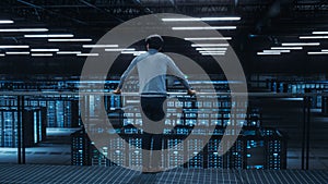 Data Center Engineer Looking Down from a Balcony on Server Farm Cloud Computing Specialist Facility