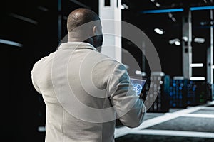 Data center engineer using AI technology on tablet