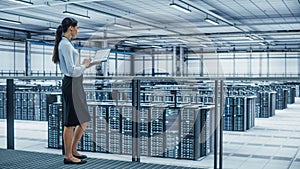 Data Center Engineer Using Laptop Computer. Server Farm Cloud Computing Specialist Facility with