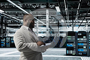 Data center engineer using laptop to automate errors detection