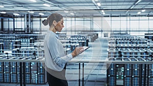 Data Center Engineer Using Tablet Computer. Server Farm Cloud Computing Specialist Facility with