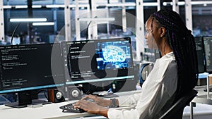 Data center female programmer uses machine learning algorithms to analyze datasets