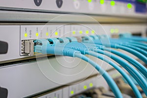 The data center has a close-up of the main links. The front panel of the Central router has many fiber-optic wires. High-speed