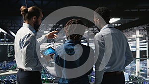 Data center manager talking with workers doing maintenance on AI supercomputers