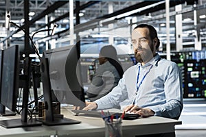 Data center programmer using PC to update servers tech, configuring gear