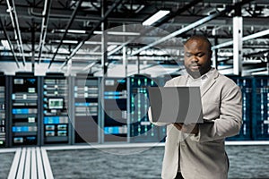 Data center software developer running error checking utilities on laptop,