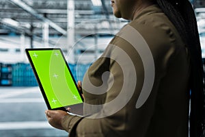 Data center software developer using green screen tablet