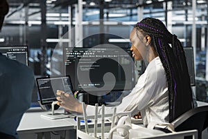 Data center software developer using tablet, deploying servers