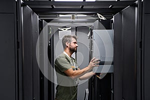 Data center technician installing and maintaining servers in a modern server rack