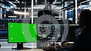 Data center technician using node tree software on mockup PC to analyze datasets